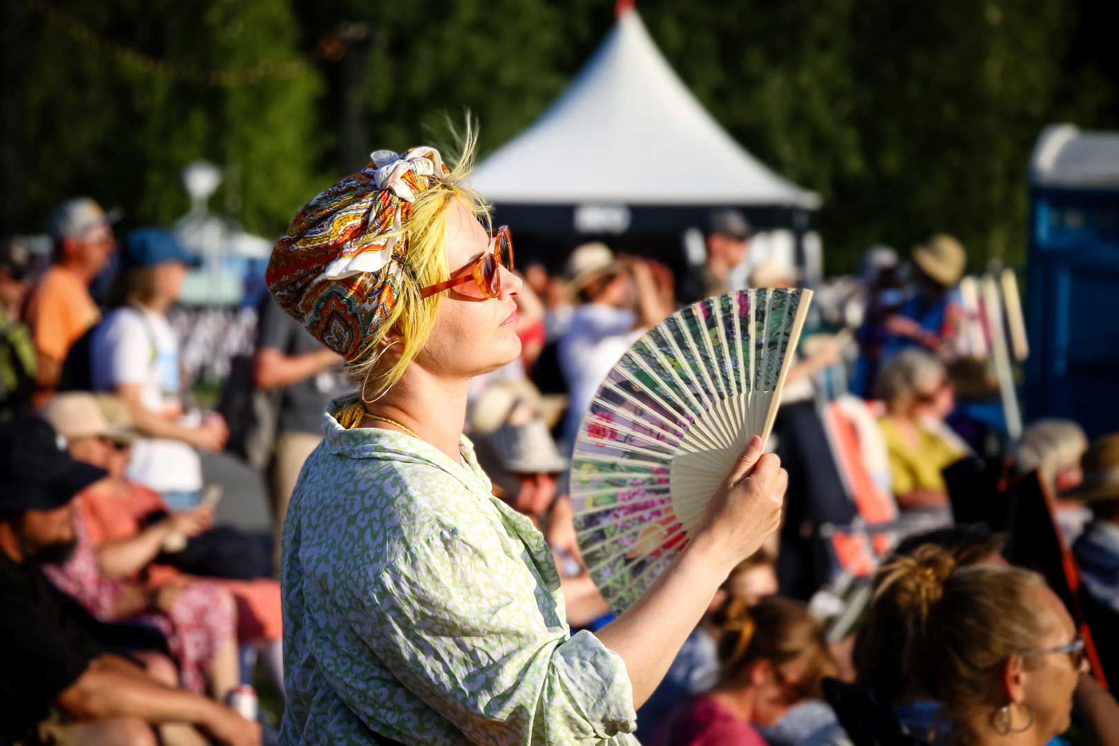 Beneath the July sun, a fan becomes both relief and rhythm for a Pori Jazz patron. Photograph: J.T. FOR FINLAND TODAY
