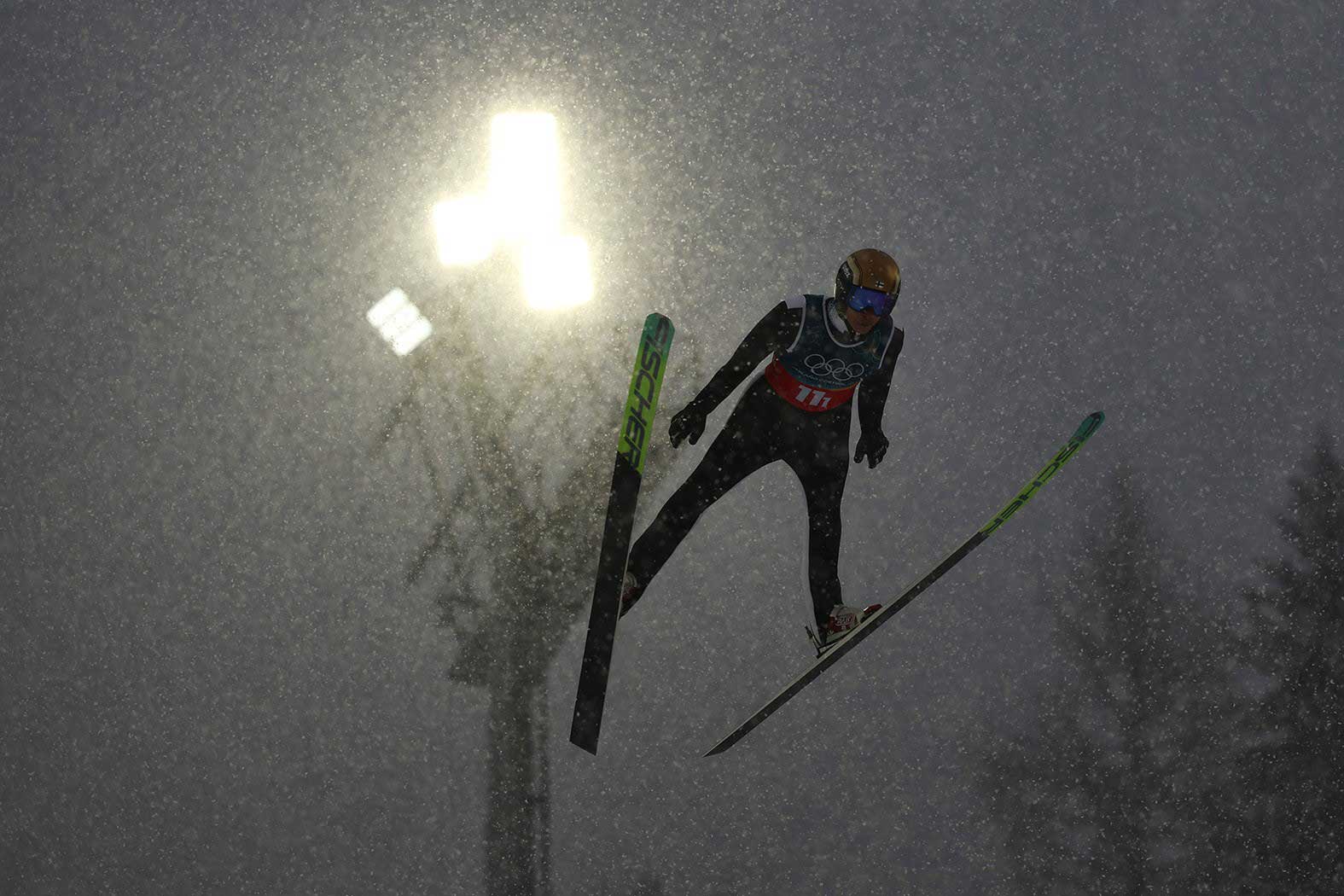 Ski jumper Eero Hirvonen is captured mid-flight against the sky during a jump in a photograph by Yohei Osada/AFLO/EASTPRESS.