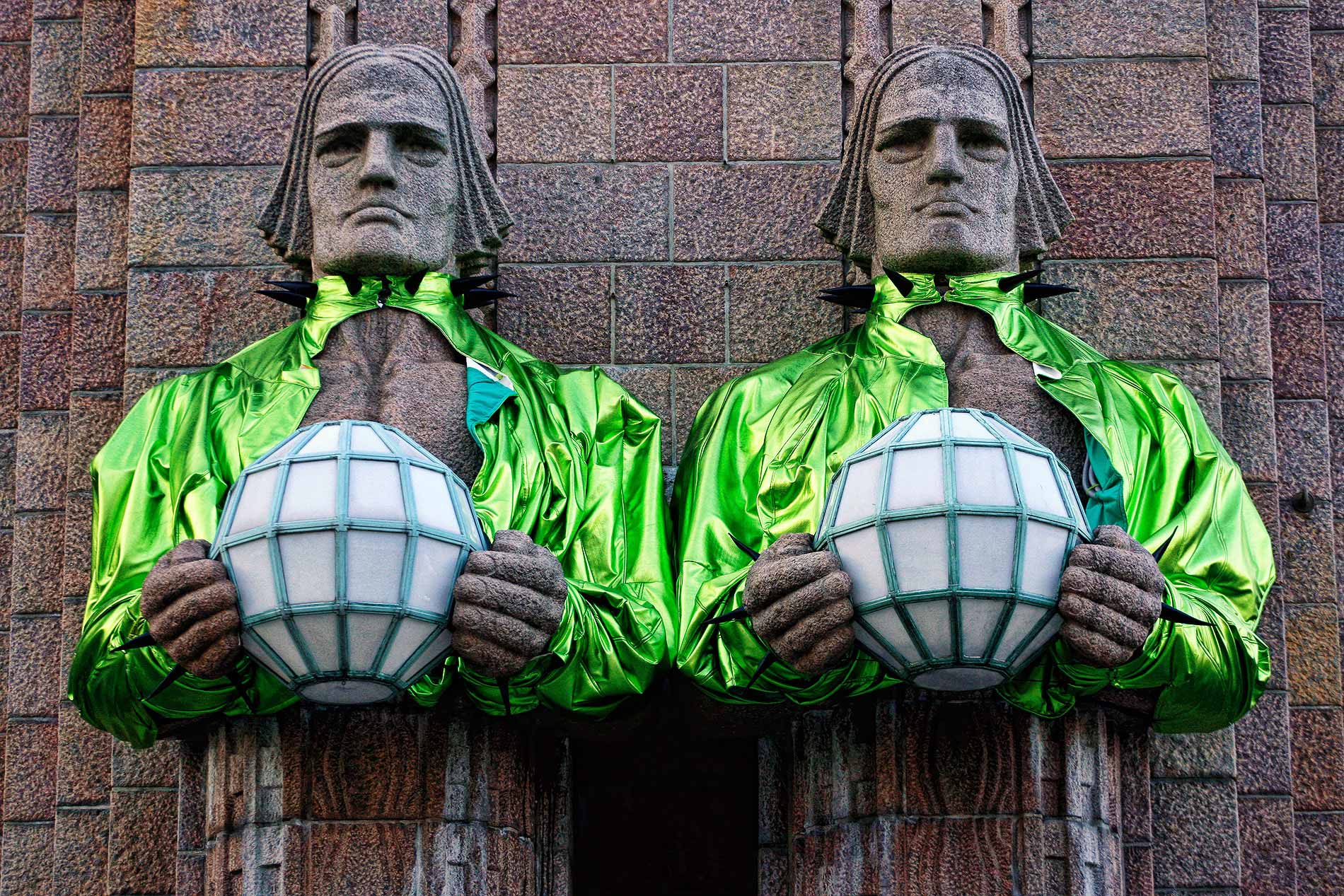 The Lantern Carriers, also known as the stone men, positioned in front of the Helsinki Railway Station, donned lime green bolero jackets in May 2023 to show their support for Käärijä during the Eurovision Song Contest. Photograph: TONY ÖHBERG/FINLAND TODAY