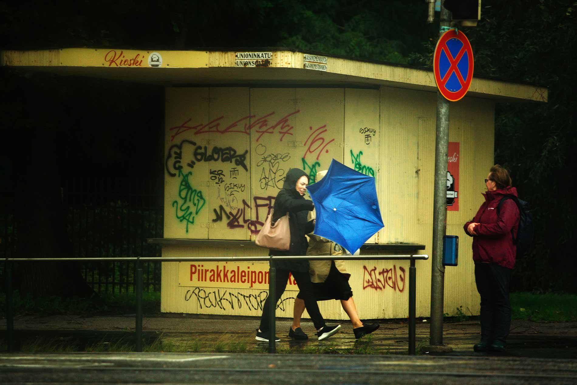 A woman battles against the fierce wind as she walks through a blizzard, struggling with an umbrella that has flipped inside out. This striking photograph was taken by Tony Öhberg for Finland Today.